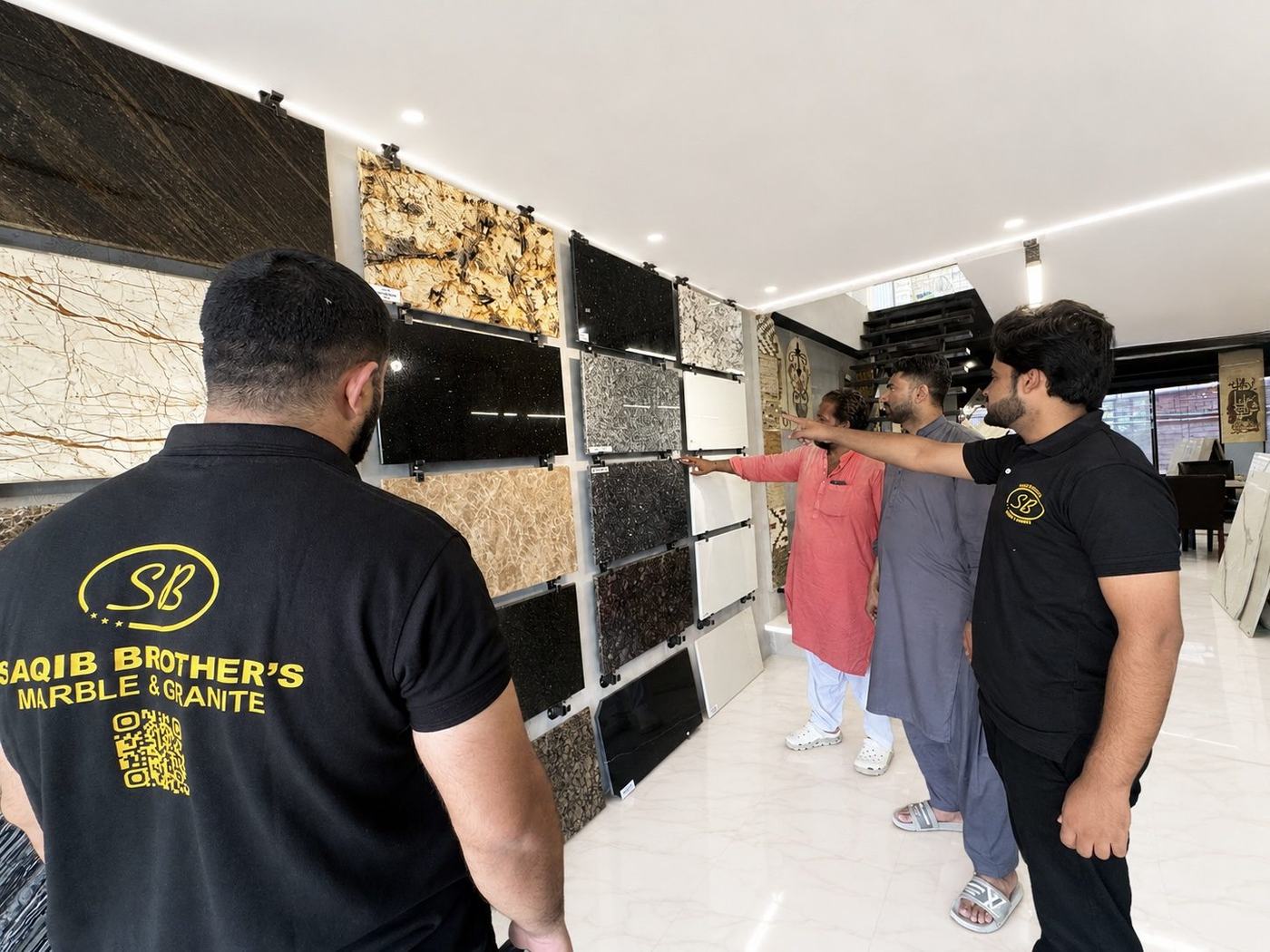 Saqib Brothers team walking clients through the sample wall