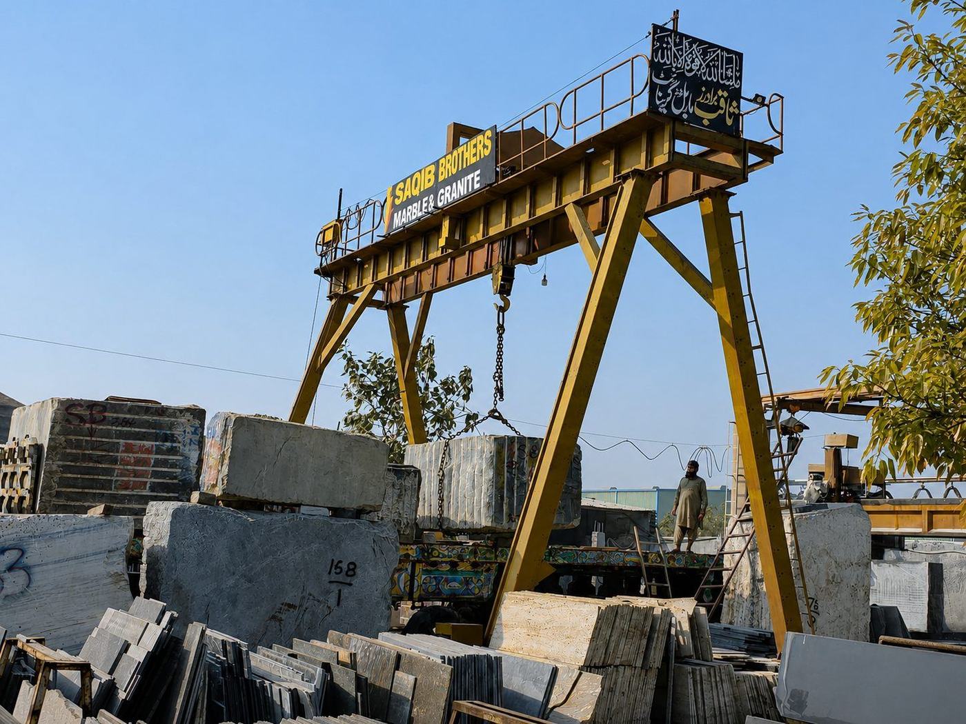Blocks being loaded onto a truck beneath the yard crane